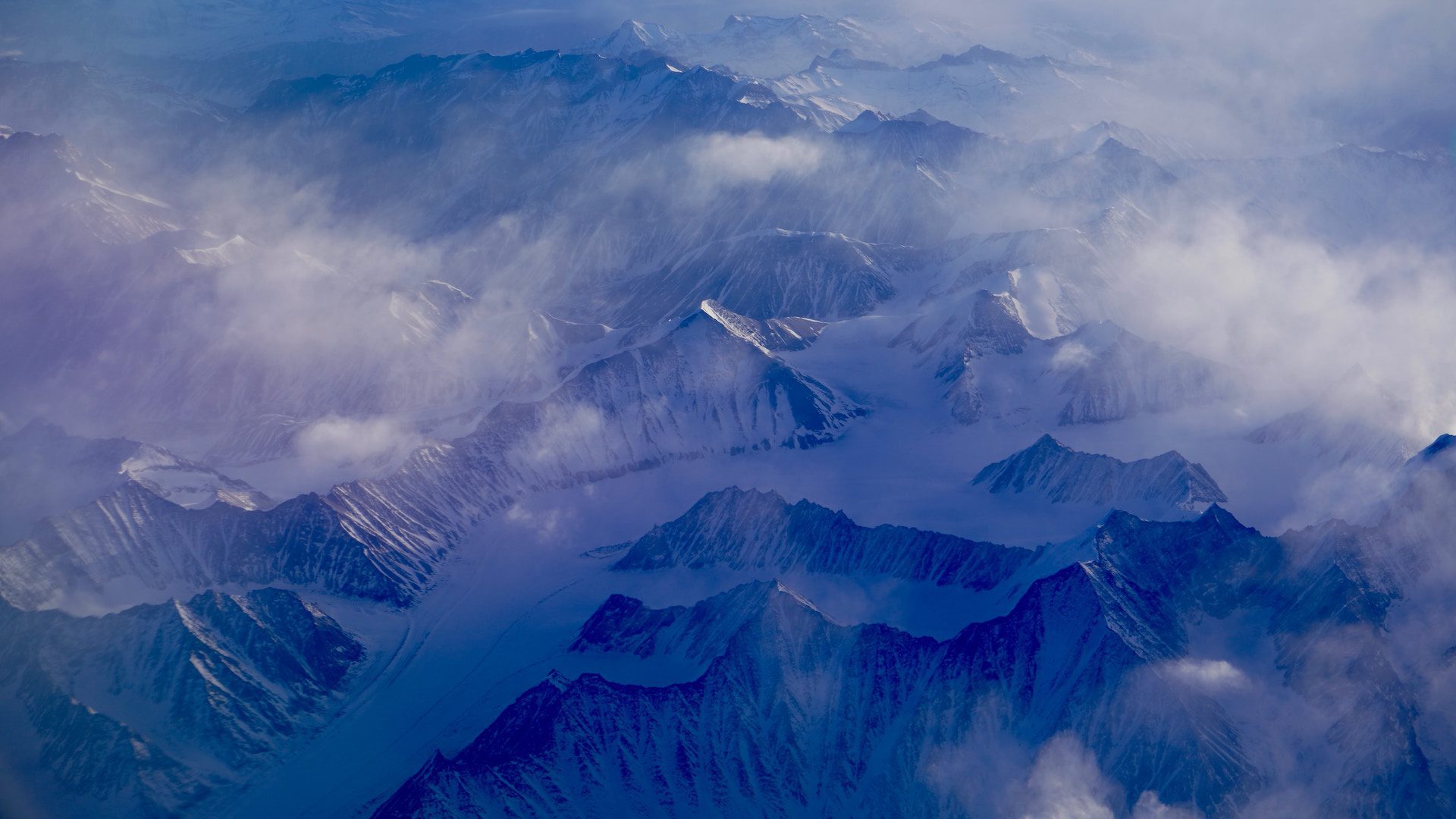 mountain tops with snow and mist