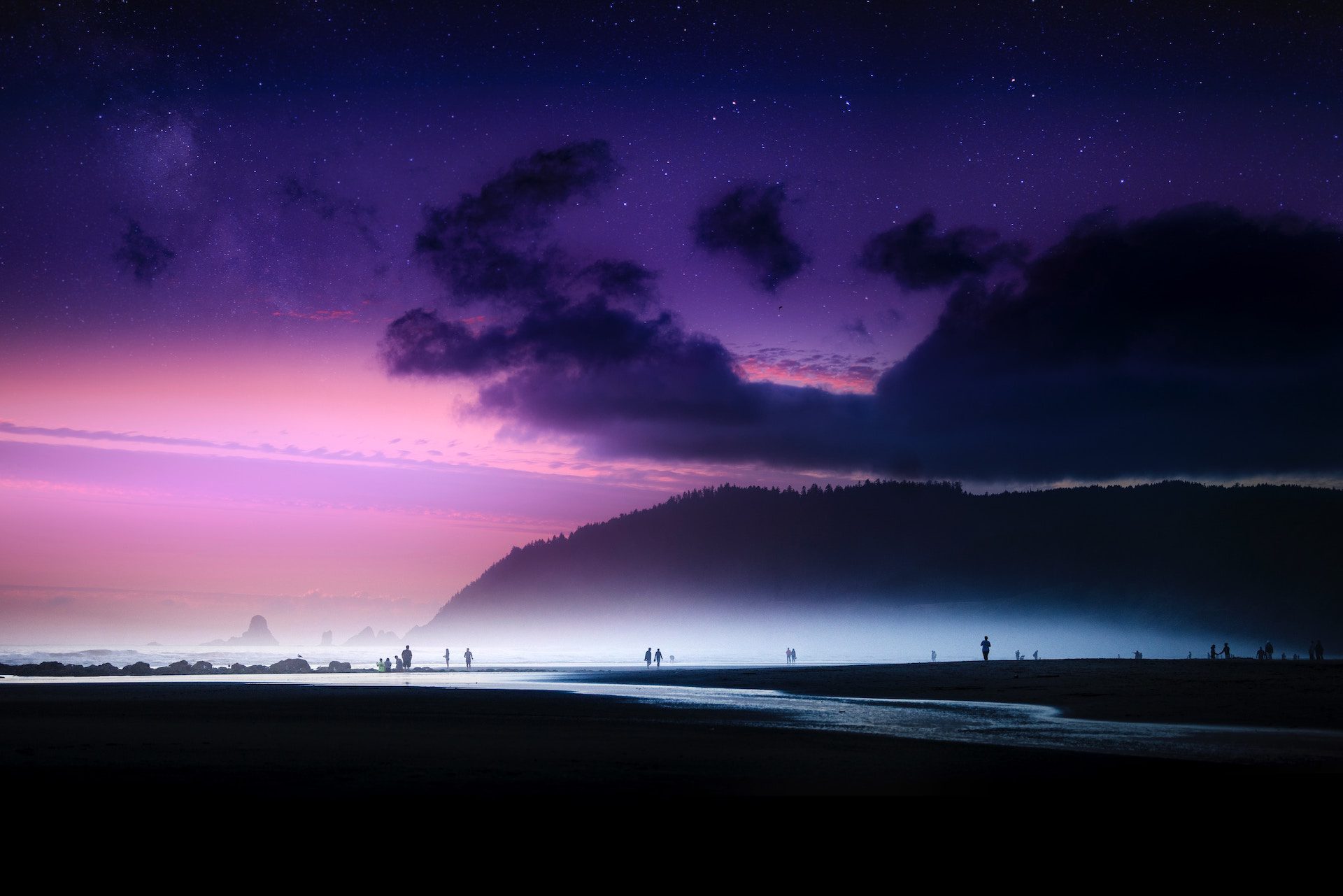 pink and purple sky with silhouettes of people