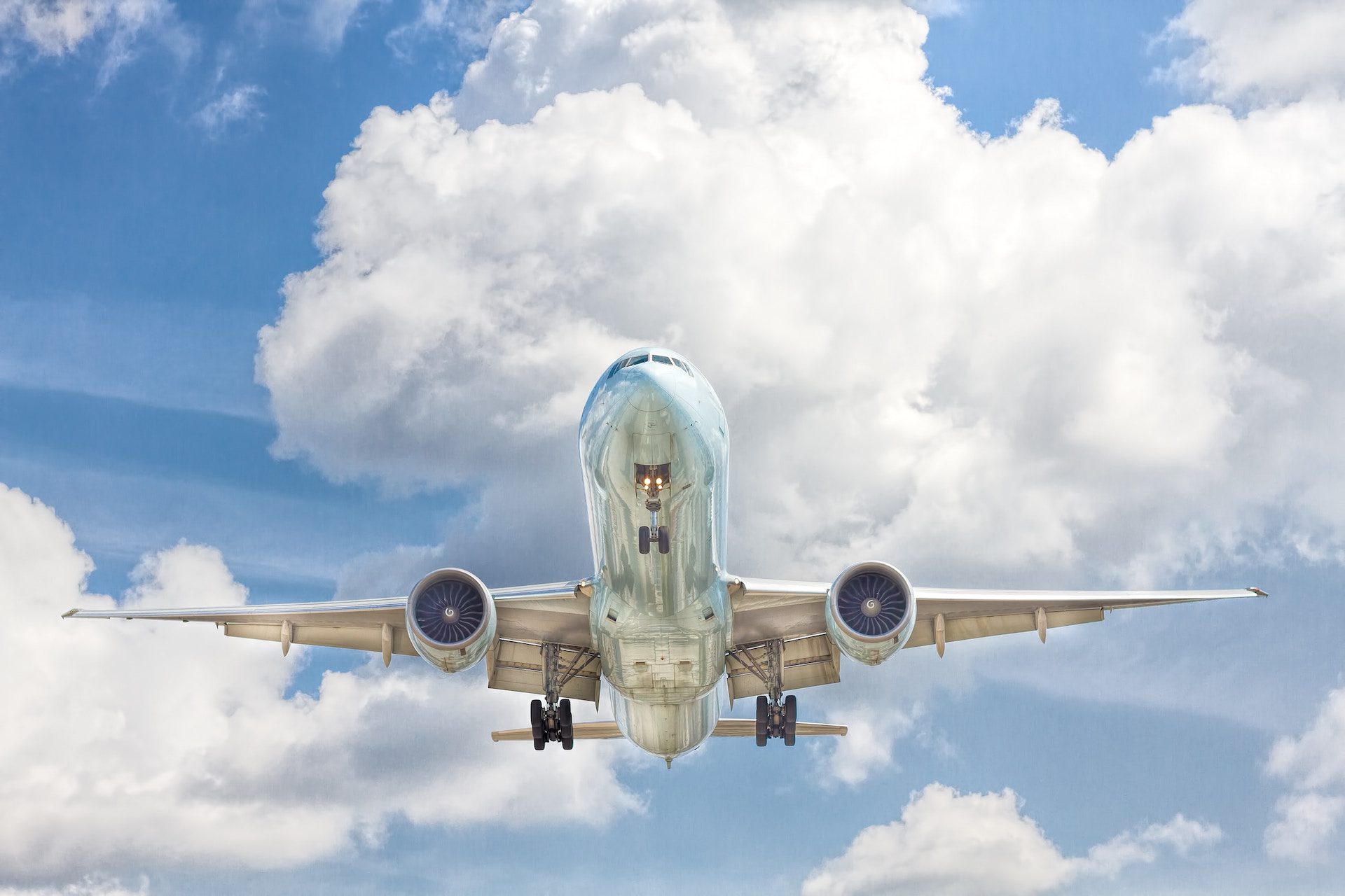 close up shot of an aeroplane underneath flying through the sky