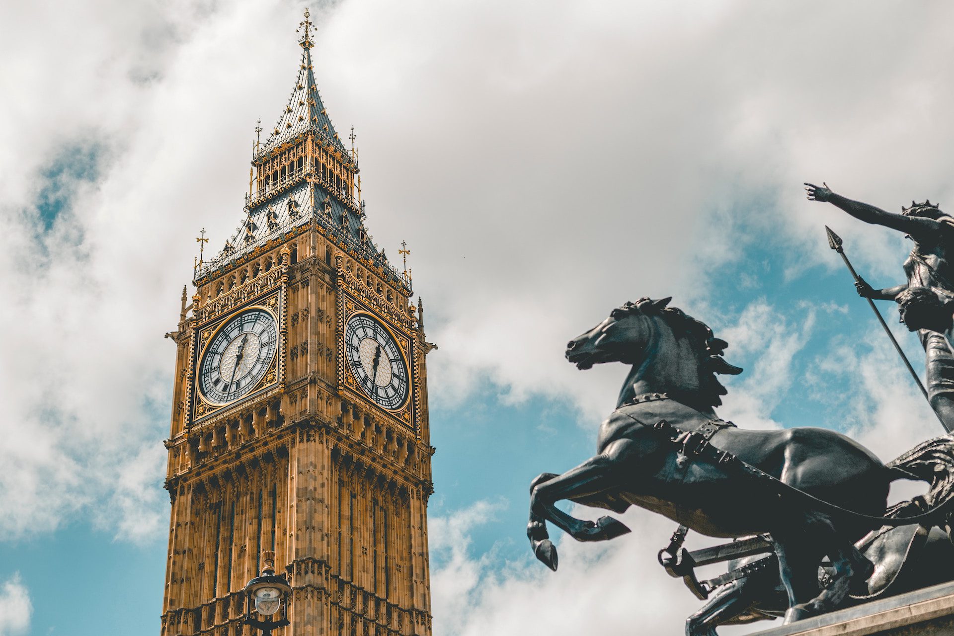 close up of Big Ben, London with statue of a man and horse