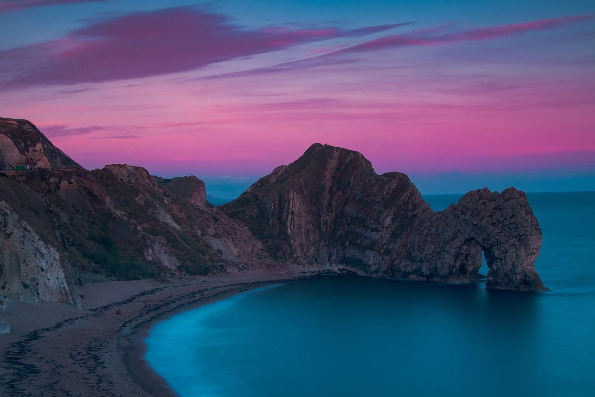 Durdle Door in dusk with a pink sky