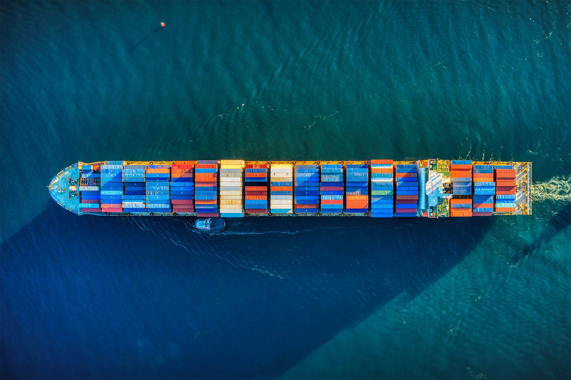 a ship with many containers on the water