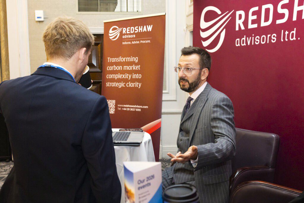 Two professionals discussing carbon markets at Carbon Forward London