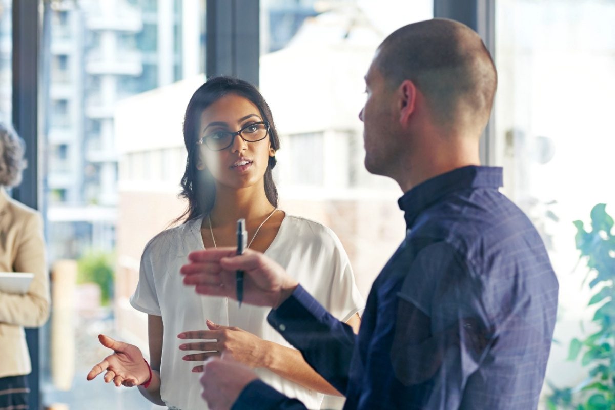 Colleagues discussing work in an office