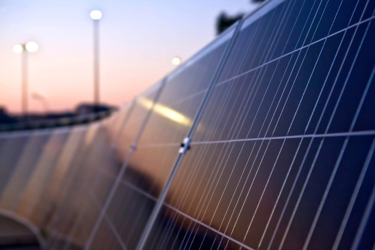 Close-up of solar panels generating renewable energy at sunset